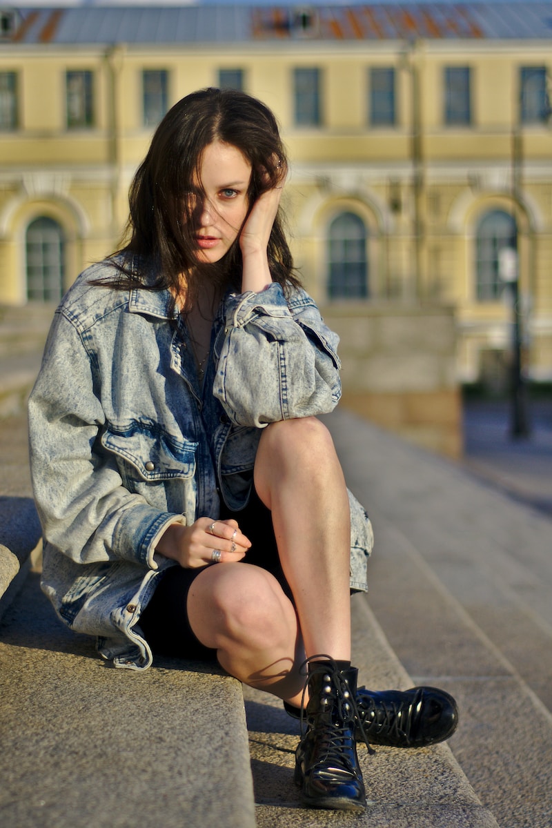 woman sitting on gray stairs
