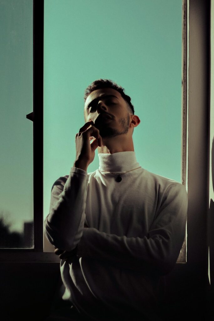 man in gray long sleeve shirt smoking cigarette