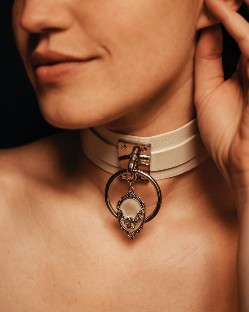 a woman wearing a white choker with a skull on it