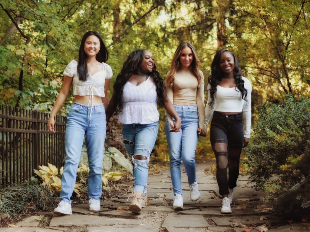 a group of young women walking down a path